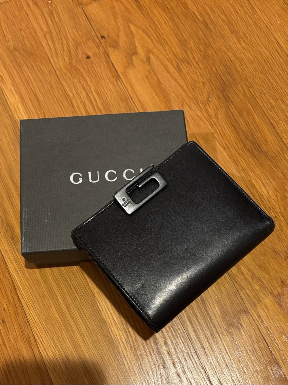 Gucci Black Leather Bi-Fold Wallet with signature G Buckle. Classic.Original box